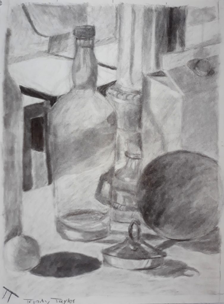 The objects in this drawing were all different colors and had different degrees of sheen, all sitting on a white table cloth.

From the left, half of a matte white wine bottle can be seen with a small styrofoam ball sitting at the bottom right corner of the bottle. The ball casts a slightly longer, dark shadow onto the table cloth to the right. Behind the shadow is a glass bottle about the same height of the wine bottle. It casts a somewhat transparent shadow to its right that just begins to touch the base of a dark bocce ball. The objects in front of the bocce ball cast shadows on its left side, although there is still a cast shadow extending from the base of the ball to the left.

A small, cylindrical shiny metal container and cone shaped lid rest between the glass bottle and the bocce ball. There is a small looped handle on top of the lid. The edge nearly touches the shadow cast from the small styrofoam ball on the left of the page. The container casts its own shadow to the right.

Behind the bocce ball sits a white milk carton, the shape of a rectangular prism. The glass bottle casts a shadow on the left side of the carton that looks like hardly anything more than an outline. A decorative, cylindrical vase is placed behind both the carton and the bottle. It's left side is bright while it's right side is dark, with a gradient of shadow in between. Indents on the vase have their own shadows and highlights. The base of the cylinder becomes like a curved stand, and the vase curves inward before curving back out again with the base extending behind the glass bottle and the milk carton. Part of the base of the vase can be seen as a refracted image in the bottle.

In the background, there are a few white desks with black table rims and legs, along with a grey chair.